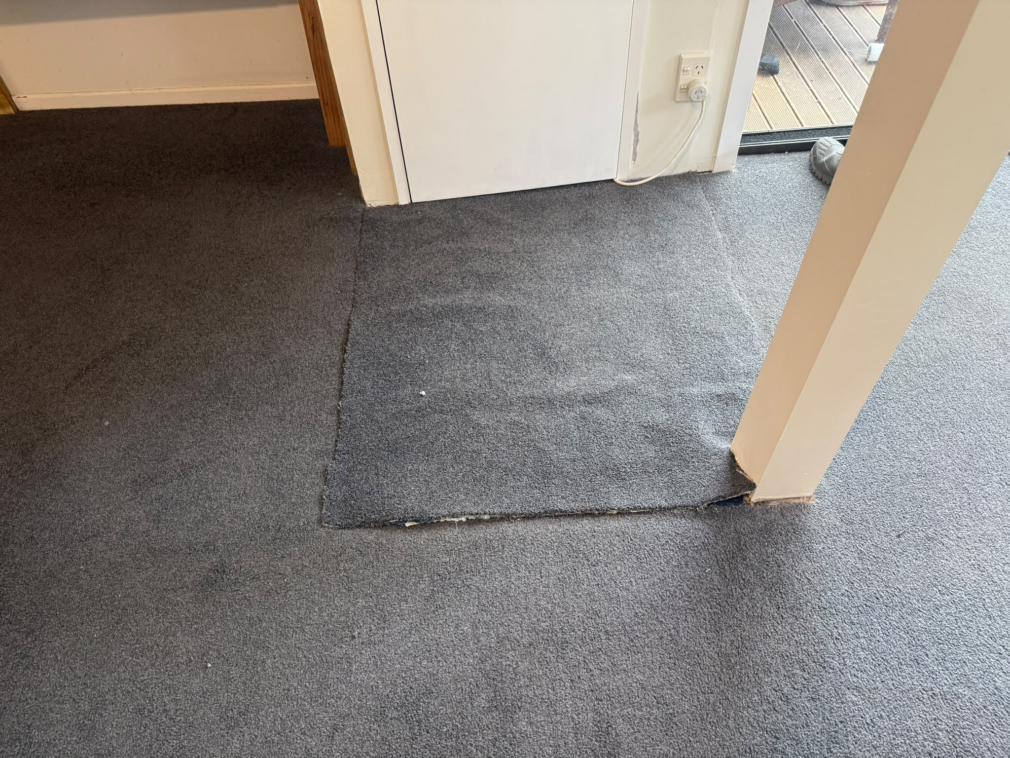 Deck doorway carpet with a replacement patch fitted into the threshold
