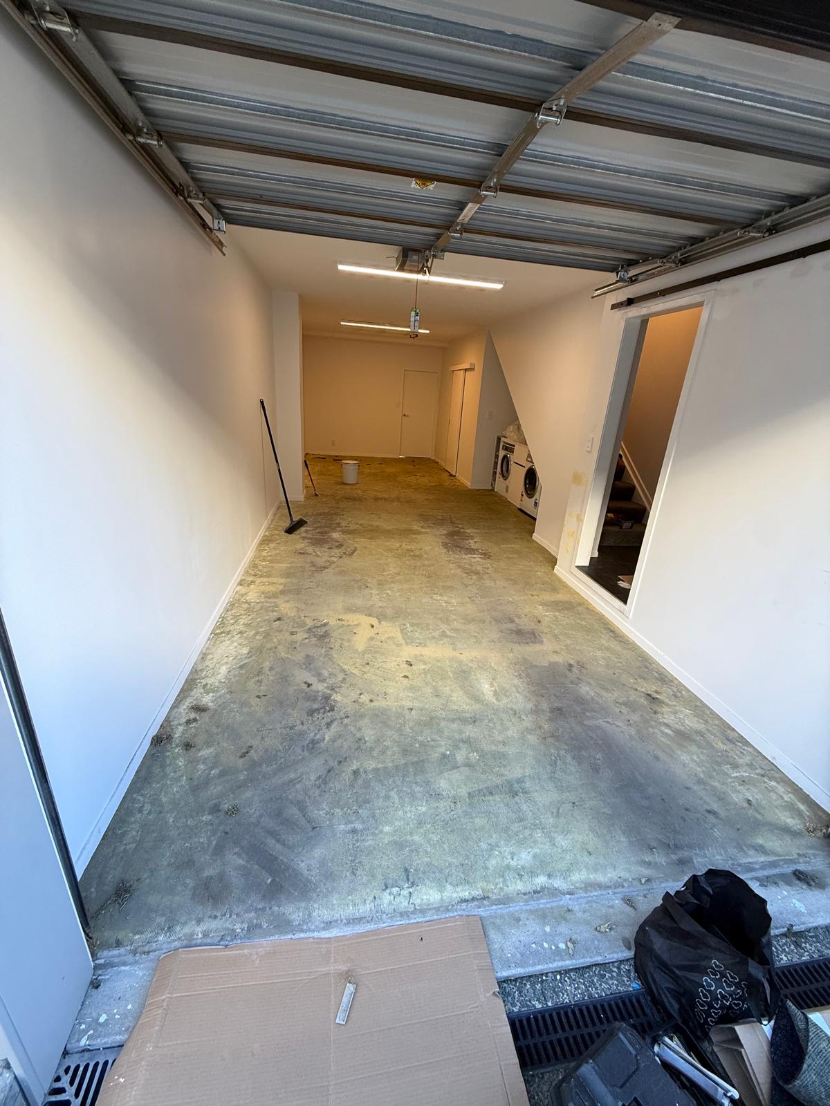 Tan carpet meeting grey tile at a hallway doorway threshold ahead of the garage installation